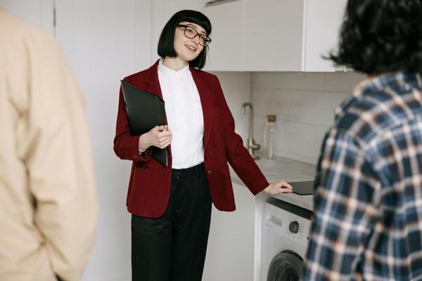 A professional woman touring a couple through a rental home