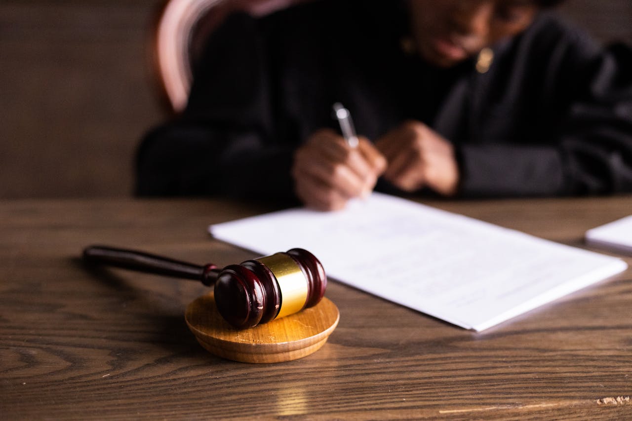 gavel and person writing lease in background