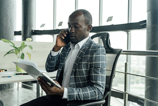 property manager talking on the phone and looking over documents