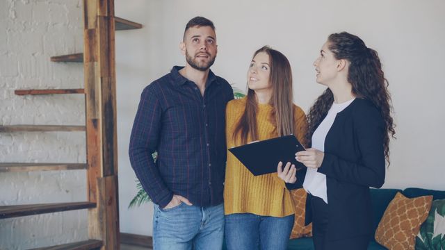 three people viewing a property interior
